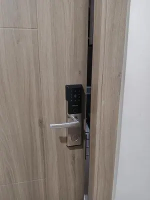 a close up of a door with a phone on it at fame residence staycation in Manila
