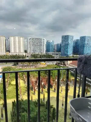 a view of a city from a balcony at VSV Luxury Family Suite staycation Moa in Manila