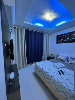 a bedroom with a bed with a blue ceiling at Kiean Leases in Manila