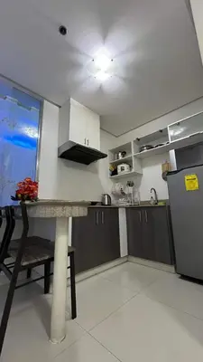 a kitchen with a table and a refrigerator at Kiean Leases in Manila