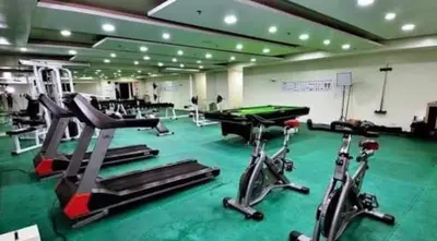 a gym with treadmill machines and a pool table at Kiean Leases in Manila