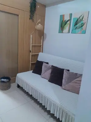 a bedroom with a bed with pillows on it at Dash Shell Residences in Manila