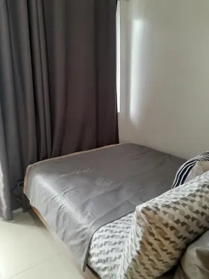 a bed sitting in a room with a window at Dash Shell Residences in Manila