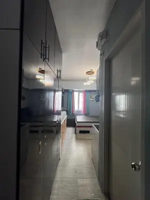 a kitchen with a hallway leading to a room at Studio Unit Amaia Skies Shaw in Manila