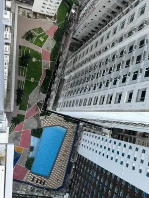 an overhead view of a building with a swimming pool at Studio Unit Amaia Skies Shaw in Manila