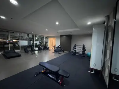 a gym with several exercise equipment in a room at Studio Unit Amaia Skies Shaw in Manila
