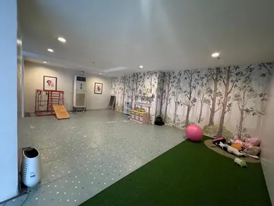 a room with a green carpet and a room with trees on the wall at Studio Unit Amaia Skies Shaw in Manila