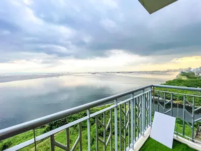 a balcony with a view of the water at Bayshore 9g 4br in Manila