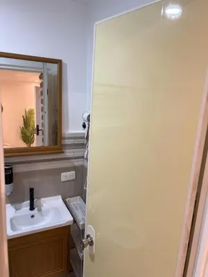 a bathroom with a sink and a mirror at Cozy Studio near MOA, Airport & Star City, Pasay in Manila