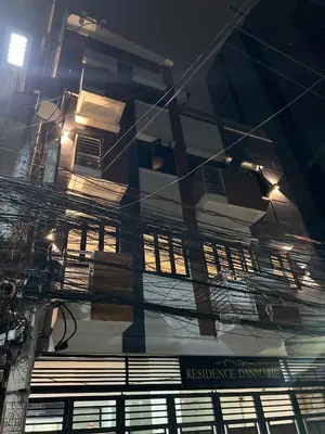 a reflection of a building in the side of a building at Cozy Studio near MOA, Airport & Star City, Pasay in Manila