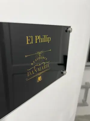 a sign for a danish restaurant with a gold logo at Cozy Studio near MOA, Airport & Star City, Pasay in Manila