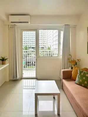 a living room with a couch and a table at Shore Residences 2 Bedroom with Balcony Near NAIA Airport MOA in Manila