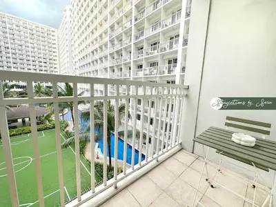 a balcony with a bench and a playground at Shore Residences 2 Bedroom with Balcony Near NAIA Airport MOA in Manila
