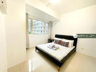 a bedroom with a bed and a window at Shore Residences 2 Bedroom with Balcony Near NAIA Airport MOA in Manila