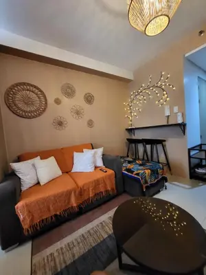 a living room with a couch and a fireplace at Balay Maria in Manila