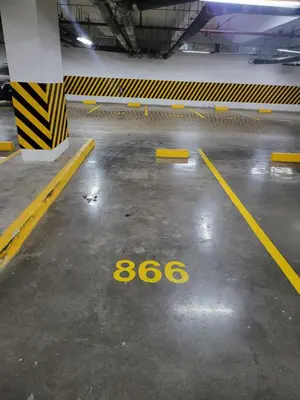 an empty parking lot with the number in a parking garage at Balay Maria in Manila
