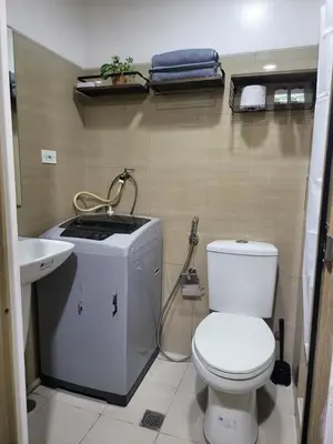 a bathroom with a toilet and a sink at Balay Maria in Manila