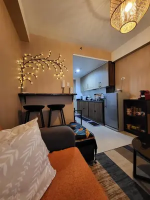 a living room with a couch and a kitchen at Balay Maria in Manila