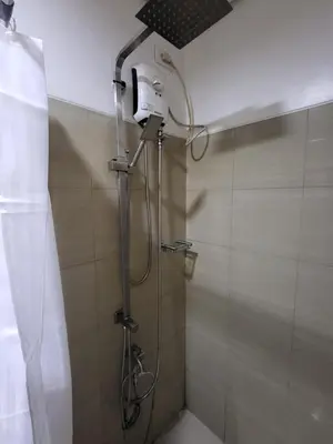 a shower with a shower head in a bathroom at Balay Maria in Manila