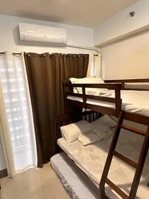 a room with two bunk beds and a window at Casa Vigonia in Manila