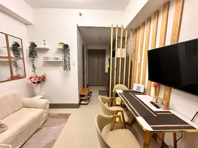a living room with a couch and a table with a television at Casa Vigonia in Manila