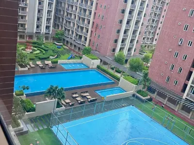 an overhead view of a pool in a apartment complex at Condotel nearby MOA with Pool Access in Manila
