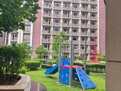 a playground in front of a large building at Condotel nearby MOA with Pool Access in Manila