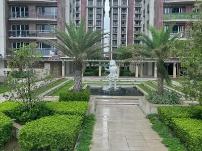 a fountain in a park with palm trees and buildings at Condotel nearby MOA with Pool Access in Manila