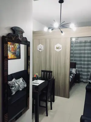 a dining room with a table and a mirror at Casa Arville in Manila