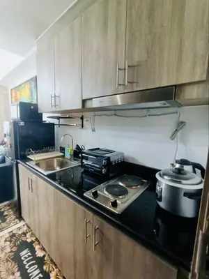 a kitchen with a stove top and a sink at Casa Arville in Manila