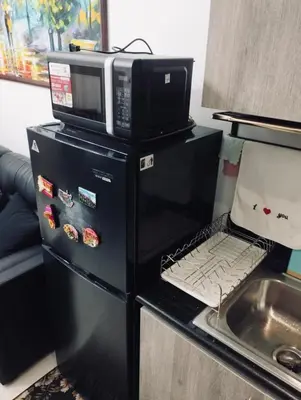 a microwave oven sitting on top of a refrigerator at Casa Arville in Manila