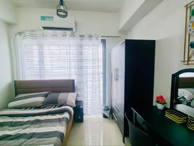 a small bedroom with a bed and a window at Casa Arville in Manila