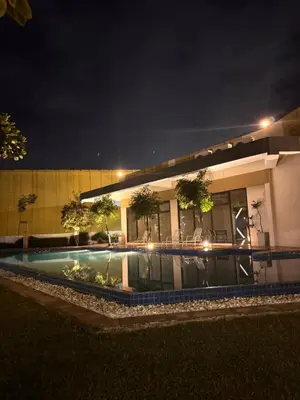 a building with a swimming pool at night at Mon Amour Haven in Taytay