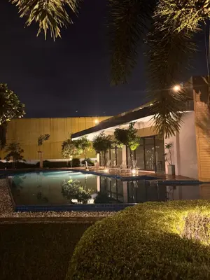 a building with a swimming pool at night at Mon Amour Haven in Taytay