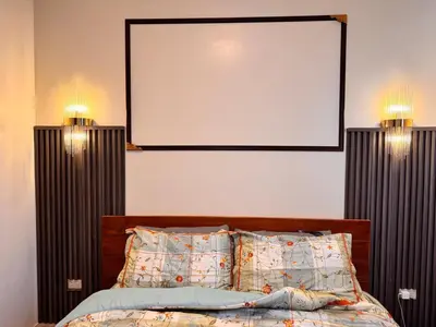 a bedroom with a bed with two lights on it at Mon Amour Haven in Taytay