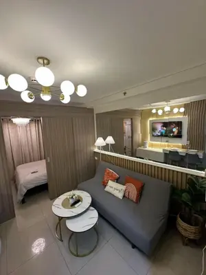a living room with a couch and a table at Shore 2 Residence Homes Near MOA in Manila