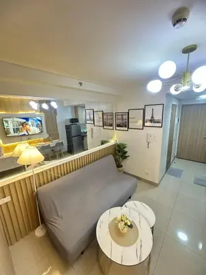 a living room with a couch and a table at Shore 2 Residence Homes Near MOA in Manila