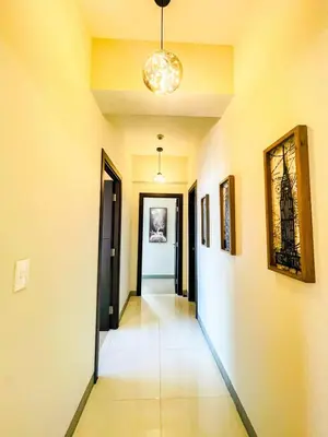 a hallway with paintings on the walls and a hallwayngthngthngthngthngthngth at Luxury 2BR Penthouse Across Uptown BGC I Modern in Manila