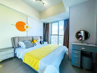 a bedroom with a large bed and a mirror at Luxury 2BR Penthouse Across Uptown BGC I Modern in Manila