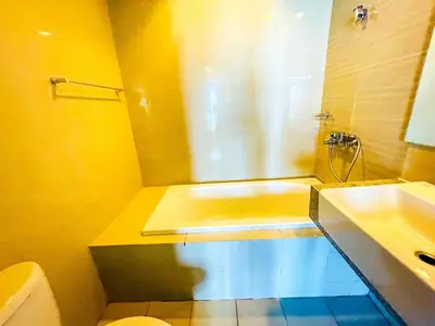 a bathroom with a tub and a toilet and a sink at Ultra-Luxury 3BR Penthouse in Uptown BGC in Manila
