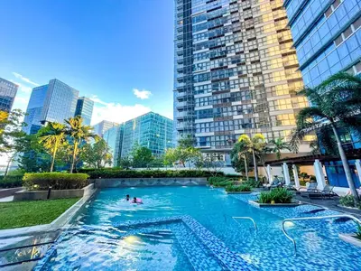 a large swimming pool in a city with tall buildings at Ultra-Luxury 3BR Penthouse in Uptown BGC in Manila