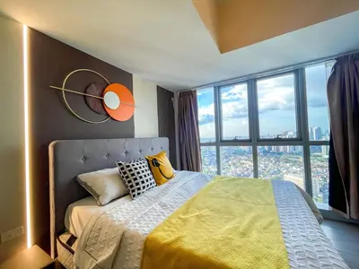 a bedroom with a bed with a large window at Ultra-Luxury 3BR Penthouse in Uptown BGC in Manila