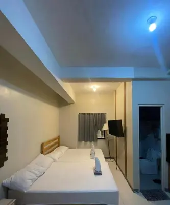 a bedroom with a bed with a blue ceiling at P3k suites barkada family room in Manila