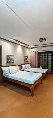 two large beds in a room with at P3k suites barkada family room in Manila
