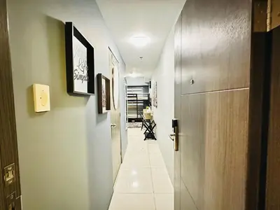 a hallway with a long corridor with a door and a room at STYLISH LUXE APARTMENT in SMDC GREEN RESIDENCES in Manila