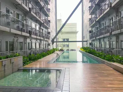 a swimming pool in the middle of a building at STYLISH LUXE APARTMENT in SMDC GREEN RESIDENCES in Manila