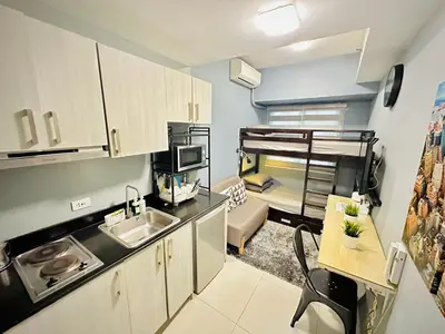 a small kitchen with a sink and a bunk bed at STYLISH LUXE APARTMENT in SMDC GREEN RESIDENCES in Manila