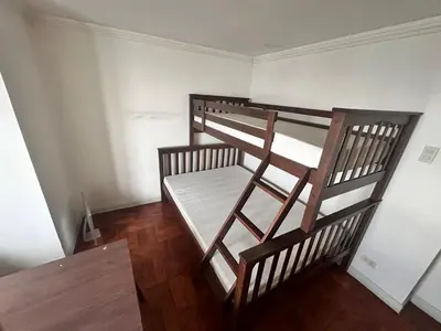 two bunk beds in a room with wooden floors at Tranquil Harbor in Manila