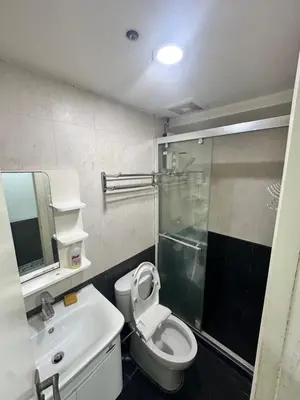 a bathroom with a toilet and a sink and a shower at Tranquil Harbor in Manila