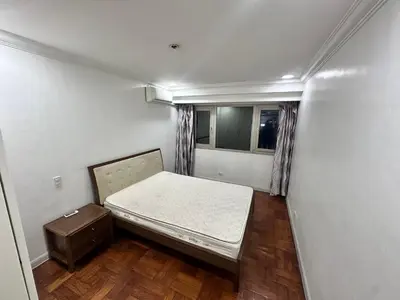 a small bedroom with a bed and a window at Tranquil Harbor in Manila